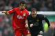 Javier Mascherano battles with Wayne Rooney during a derby game.