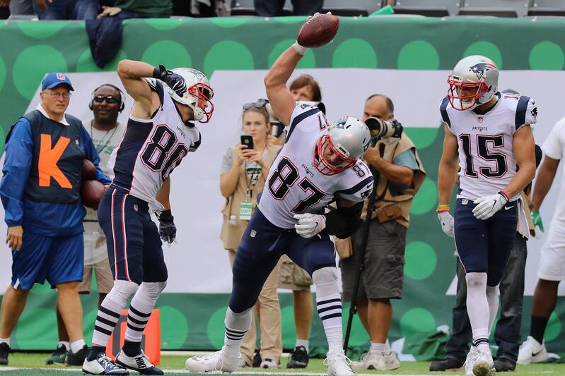 EAST RUTHERFORD, NJ - OCTOBER 15: Tight end Rob Gronkowski #87 of the New England Patriots celebrates with teammates wide receiver Danny Amendola #80 and wide receiver Chris Hogan #15 during the second quarter of their game against the New York Jets at
