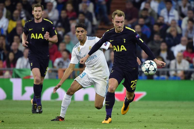 Tottenham Hotspur's Danish midfielder Christian Eriksen (R) controls the ball next to Real Madrid's Moroccan defender Achraf Hakimi during the UEFA Champions League group H football match Real Madrid CF vs Tottenham Hotspur FC at the Santiago Bernabeu sta