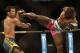 Machida wards off a kick from Phil Davis in their fight in 2013.