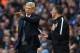 Arsenal's French manager Arsene Wenger (L) speaks to fourth official Andre Marriner after they concede their third goal during the English Premier League football match between Manchester City and Arsenal at the Etihad Stadium in Manchester, north west En
