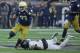 SOUTH BEND, IN - NOVEMBER 04: Josh Adams #33 of the Notre Dame Fighting Irish breaks a tackle attempt by Cameron Glenn #2 of the Wake Forest Demon Deacons at Notre Dame Stadium on November 4, 2017 in South Bend, Indiana. Notre Dame defeated Wake Forest 4
