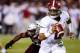 STARKVILLE, MS - NOVEMBER 11: Jalen Hurts #2 of the Alabama Crimson Tide scrambles away from pressure from J.T. Gray #12 of the Mississippi State Bulldogs during the second half of an NCAA football game at Davis Wade Stadium on November 11, 2017 in Starkv