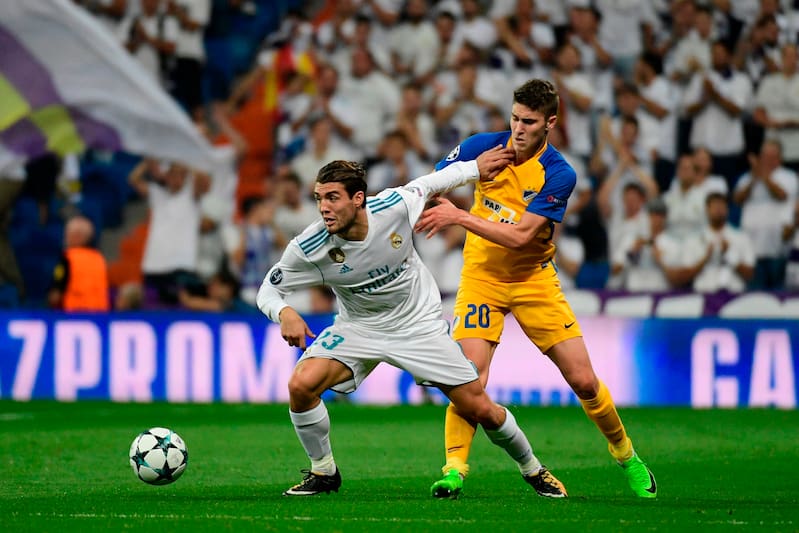 Real Madrid's midfielder from Croatia Mateo Kovacic (L) vies with APOEL Nicosia's midfielder from Hungary Roland Sallai during the UEFA Champions League football match Real Madrid CF vs APOEL FC at the Santiago Bernabeu stadium in Madrid on September 13,