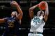 Cassius Winston takes a rebound away from Bonzie Colson.