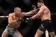 NEW YORK, NY - NOVEMBER 04: (L-R) Georges St-Pierre of Canada punches Michael Bisping of England in their UFC middleweight championship bout during the UFC 217 event inside Madison Square Garden on November 4, 2017 in New York City. (Photo by Brandon Mag