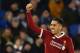 Liverpool's Brazilian midfielder Roberto Firmino celebrates scoring their third goal during the English Premier League football match between Brighton and Hove Albion and Liverpool at the American Express Community Stadium in Brighton, southern England on