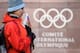 A supporter stands with a Russian flag in front of the logo of the International Olympic Committee (IOC) at the headquarters on December 5, 2017 in Pully near Lausanne.
The International Olympic Committee meets to decide whether to bar Russia from the 201