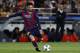 Barcelona's Argentinian forward Lionel Messi kicks the ball on a free-kick while Bayern Munich's Spanish head coach Pep Guardiola looks on during the UEFA Champions League football match FC Barcelona vs FC Bayern Muenchen at the Camp Nou stadium in Barcel