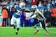 MIAMI GARDENS, FL - DECEMBER 11: Kenyan Drake #32 of the Miami Dolphins tries to avoid the tackle by Elandon Roberts #52 of the New England Patriots during the first quarter at Hard Rock Stadium on December 11, 2017 in Miami Gardens, Florida. (Photo by C