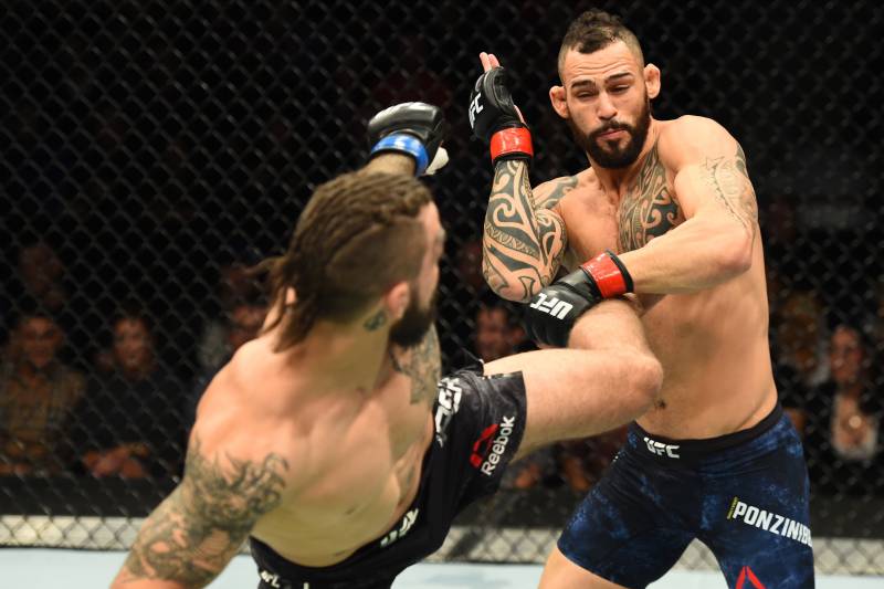 WINNIPEG, CANADA - DECEMBER 16: (L-R) Mike Perry kicks Santiago Ponzinibbio of Argentina in their welterweight bout during the UFC Fight Night event at Bell MTS Place on December 16, 2017 in Winnipeg, Manitoba, Canada. (Photo by Josh Hedges/Zuffa LLC/Zuf