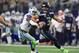 ARLINGTON, TX - DECEMBER 24: Russell Wilson #3 of the Seattle Seahawks runs away from DeMarcus Lawrence #90 of the Dallas Cowboys in the second half at AT&T Stadium on December 24, 2017 in Arlington, Texas. (Photo by Ronald Martinez/Getty Images)