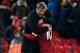 Liverpool's German manager Jurgen Klopp (L) hugs Liverpool's Brazilian midfielder Philippe Coutinho (R) applauds after the final whistle during the English Premier League football match between Liverpool and Swansea City at Anfield in Liverpool, north wes