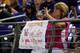 BALTIMORE, MD - AUGUST 10: A fan uses her phone behind a sign referring to former San Francisco 49ers quarterback Colin Kaepernick in the second half of the Washington Redskins and Baltimore Ravens preseason game at M&T Bank Stadium on August 10, 2017 in