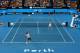 PERTH, AUSTRALIA - JANUARY 06: Roger Federer of Switzerland, partnered with Belinda Bencic of Switzerland serves to Angelique Kerber of Germany, partnered with Alexander Zverev during the mixed doubles finals match against on day eight during the 2018 Hop