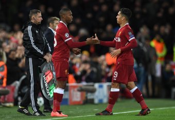 Liverpool's Brazilian midfielder Roberto Firmino (R) shakes hands with Liverpool's English striker Daniel Sturridge (L) as Firmino is substituted during the UEFA Champions League Group E football match between Liverpool and Spartak Moscow at Anfield in Li
