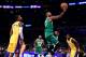 LOS ANGELES, CA - JANUARY 23: Kyrie Irving #11 of the Boston Celtics scores on a layup past Kentavious Caldwell-Pope #1 of the Los Angeles Lakers during a 108-107 Laker win at Staples Center on January 23, 2018 in Los Angeles, California. (Photo by Harr