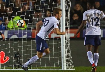 Tottenham Hotspur's English striker Harry Kane (C) turns to celebrate after scoring their first goal during the English FA Cup fourth round football match between Newport County and Tottenham Hotspur at Rodney Parade in Newport, in south Wales, on January