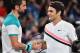 Switzerland's Roger Federer (R) shakes hands as he celebrates beating Croatia's Marin Cilic in their men's singles final match on day 14 of the Australian Open tennis tournament in Melbourne on January 28, 2018. / AFP PHOTO / Greg Wood / -- IMAGE RESTRICT