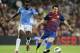 Roland Lamah (left) marking Leo Messi during his spell in Spain