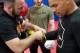 Conolley helps Anders gear up for sparring.