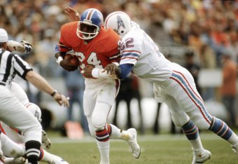 DENVER, CO - November 2: Otis Armstrong #24 of the Denver Broncos gets tackled by Robert Brazile #52 of the Houston Oilers during an NFL football game November 2, 1980 at Mile High Stadium in Denver, Colorado. Brazile played for the Oilers from 1975-84. (
