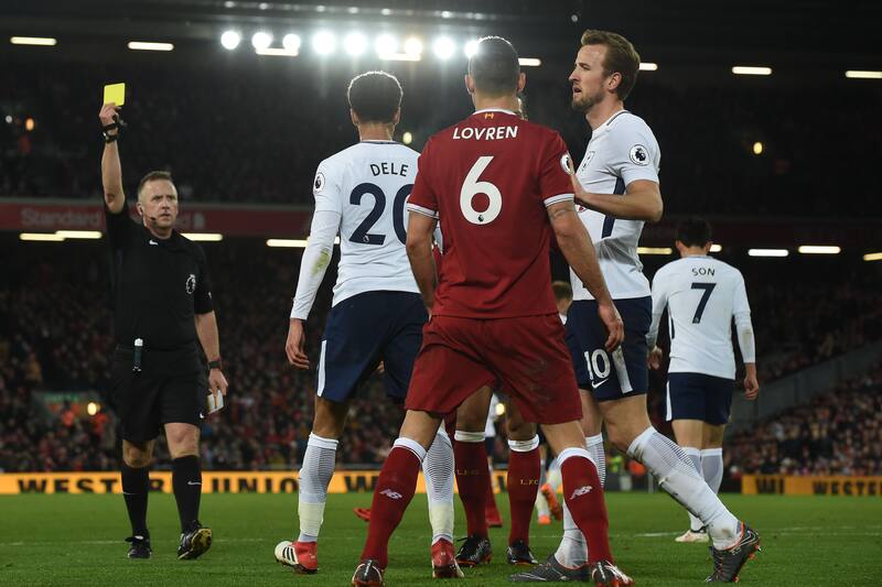 Tottenham Hotspur's English midfielder Dele Alli (2L) is booked for a dive during the English Premier League football match between Liverpool and Tottenham Hotspur at Anfield in Liverpool, north west England on February 4, 2018. / AFP PHOTO / PAUL ELLIS /