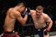 PERTH, AUSTRALIA - FEBRUARY 11: (R-L) Jake Matthews of Australia punches Li Jingliang of China in their welterweight bout during the UFC 221 event at Perth Arena on February 11, 2018 in Perth, Australia. (Photo by Jeff Bottari/Zuffa LLC/Zuffa LLC via Get