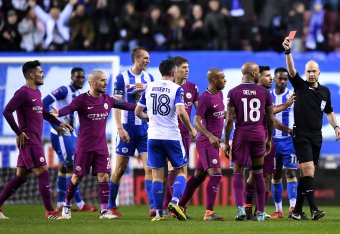 WIGAN, ENGLAND - FEBRUARY 19:  Fabian Delph of Manchester City is shown a red card by referee Anthony Taylor during the Emirates FA Cup Fifth Round match between Wigan Athletic and Manchester City at DW Stadium on February 19, 2018 in Wigan, England.  (Ph
