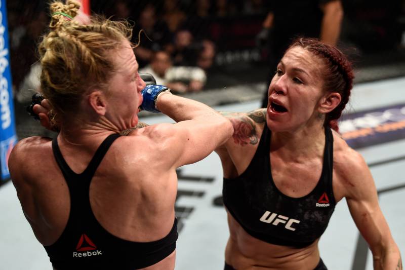 LAS VEGAS, NV - DECEMBER 30: (R-L) Cris Cyborg of Brazil punches Holly Holm in their women's featherweight bout during the UFC 219 event inside T-Mobile Arena on December 30, 2017 in Las Vegas, Nevada. (Photo by Jeff Bottari/Zuffa LLC/Zuffa LLC via Getty