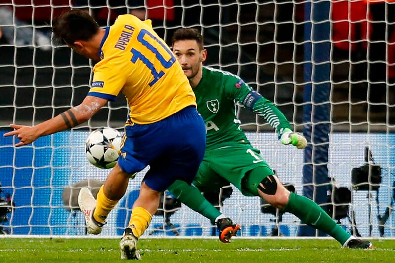 Juventus' Argentinian striker Paulo Dybala (L) scores their second goal during the UEFA Champions League round of sixteen second leg football match between Tottenham Hotspur and Juventus at Wembley Stadium in London, on March 7, 2018. / AFP PHOTO / IKIMAG