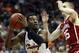 KANSAS CITY, MO - MARCH 07: Cameron McGriff #12 of the Oklahoma State Cowboys controls the ball as Brady Manek #35 of the Oklahoma Sooners defends during the first round of the Big 12 Basketball Tournament at the Sprint Center on March 7, 2018 in Kansas