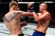 Alexander Volkov (left) punches Stefan Struve