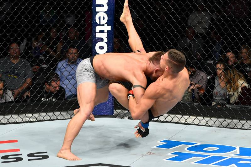 Tom Duquesnoy (right) gets taken down by Cody Stamann in his last bout.