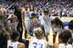 The UConn Huskies huddle around coach Geno Auriemma.