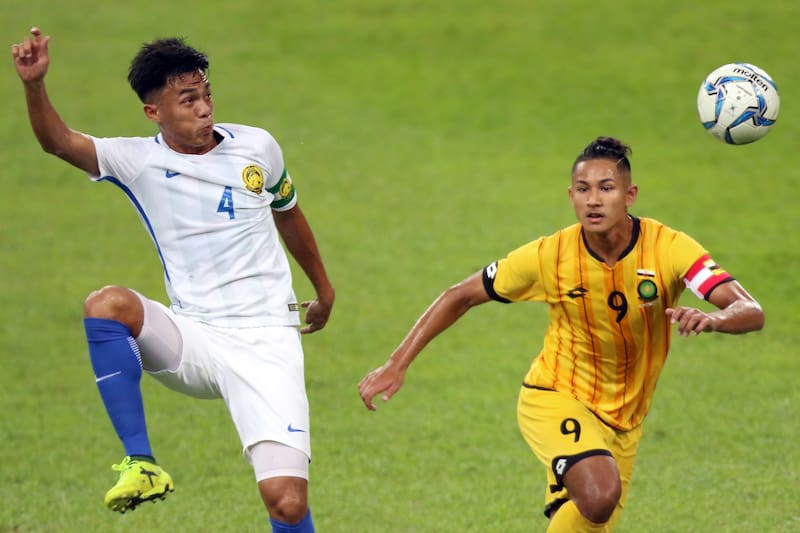 Faiq (right) in action for Brunei