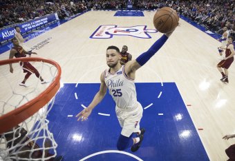 PHILADELPHIA, PA - APRIL 6: Ben Simmons #25 of the Philadelphia 76ers dunks the ball past LeBron James #23 of the Cleveland Cavaliers in the second quarter at the Wells Fargo Center on April 6, 2018 in Philadelphia, Pennsylvania. The 76ers defeated the Ca