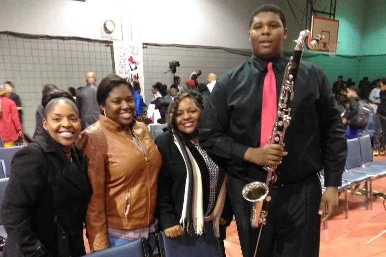 Kiyaunta Goodwin, pictured with his bass clarinet, with his family after a band concert.