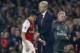 Arsenal's Chilean striker Alexis Sanchez passes Arsenal's French manager Arsene Wenger as he substituted off of the pitch during the English Premier League football match between Arsenal and West Bromwich Albion at the Emirates Stadium in London on Septem