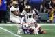 ATLANTA, GA - JANUARY 1: The UCF knight steps Shaquem Griffin # 18 over Auburn Tigers' Jarrett Stidham # 8 after being in the second quarter during the Chick-fil-A Peach Bowl at the Mercedes-Benz Stadium on January 1st 2018 in Atlanta, Georgia