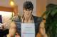 A statue of Kenshiro from 'Fist of the North Star' sits in the gym's entryway, displaying the schedule of events.