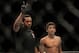 Referee Herb Dean takes points from Alex Caceres for fouling Edwin Figueroa at UFC 143.