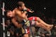 Chad Mendes (left) tries to take down Jose Aldo at UFC 142. Late in the first round, Aldo grabbed the fence to stop Mendes from taking him to the floor.
