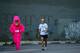 SAN FRANCISCO - MAY 17: Two participants, one in costume, walk through a parking lot to get to the start of the ING Bay to Breakers race May 17, 2009 in San Francisco, California. Now in its 98th year, the ING Bay to Breakers 12K is one of the world's l