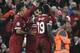 Liverpool's Egyptian midfielder Mohamed Salah (C) celebrates after scoring with Liverpool's Brazilian midfielder Roberto Firmino (L) and Liverpool's Senegalese midfielder Sadio Mane during the UEFA Champions League first leg semi-final football match betw