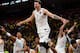TOPSHOT - Real Madrid's Slovenian Luka Doncic (C-7) jumps over the barrier as the team celebrates their 85-80 win in the Euroleague Final Four finals basketball match between Real Madrid and Fenerbahce Dogus Istanbul at The Stark Arena in Belgrade on May