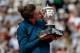 TOPSHOT - Romania's Simona Halep kisses her trophy, after winning the women's singles final match against Sloane Stephens of the US, on day fourteen of The Roland Garros 2018 French Open tennis tournament in Paris on June 9, 2018. (Photo by Thomas SAMSON