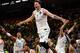 TOPSHOT - Real Madrid's Slovenian Luka Doncic (C-7) jumps over the barrier as the team celebrates their 85-80 win in the Euroleague Final Four finals basketball match between Real Madrid and Fenerbahce Dogus Istanbul at The Stark Arena in Belgrade on May