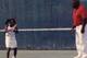 Diamond getting a tennis lesson, though she admits she wished she could have been playing more baseball instead.