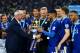 LEICESTER, ENGLAND - MAY 07: Claudio Ranieri Manager of Leicester City passes the Premier League Trophy to Kasper Schmeichel and Riyad Mahrez as players and staffs celebrate the season champions after the Barclays Premier League match between Leicester C
